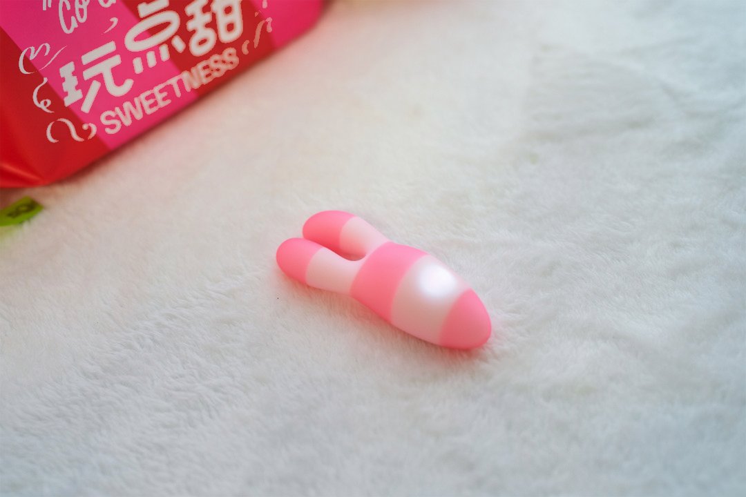 口哨糖登场:两个粉色软环与糖果主题包装